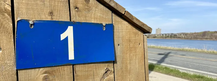 Blue civic-address sign with the number one